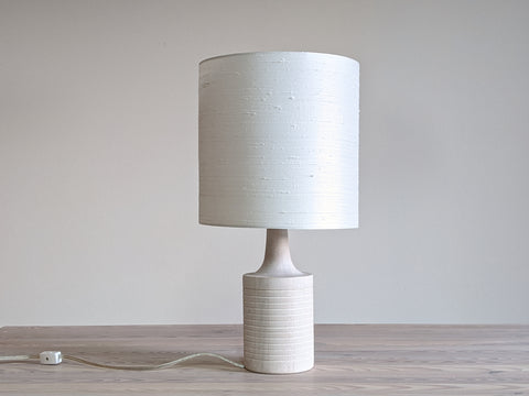 drum lampshade in white silk on a white oiled table lamp