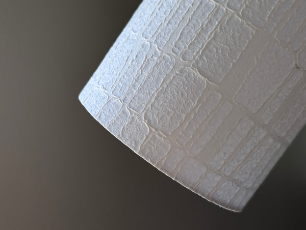 white textured lamp shade made of geometric paper