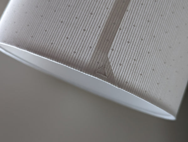 close up of a lamp shade's back seam showing the triangle stitch detail in white by Ud Form