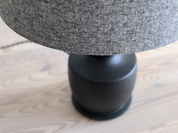 Close up of charcoal lamp shade with black lamp base.