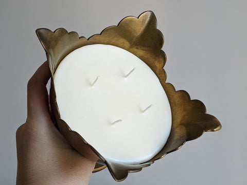 top view of vintage brass pedestal candle being held by a hand