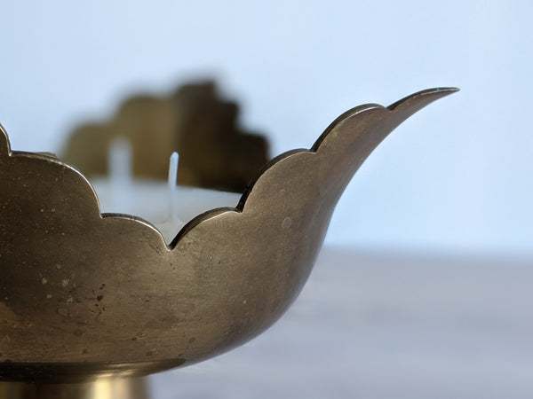 close up shot of edge detail on scalloped brass candle