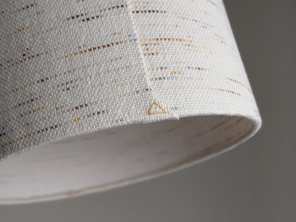 close up image of lamp shade seam with a yellow triangle stitch detail