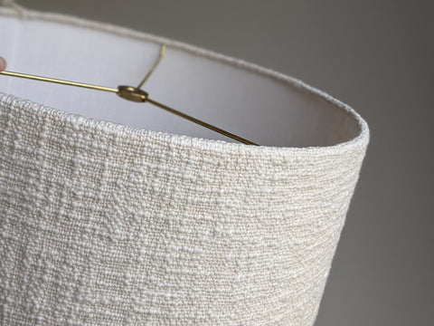 close up of edge details on a cream colored, handwoven fabric lamp shade