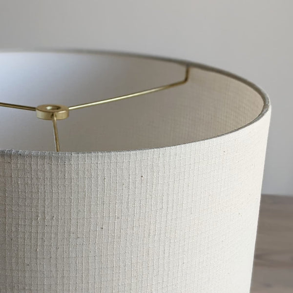 close up of handmade lamp shade in Grid Ecru fabric with brass spider hardware