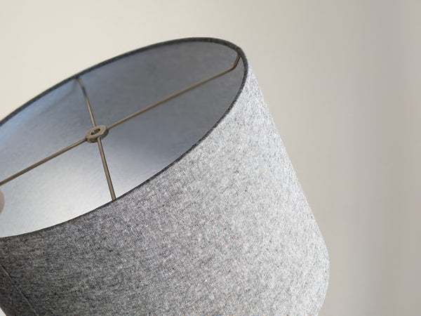 close up of lamp shade shown at an angle with the nickel hardware and top edge of the shade tilted forward