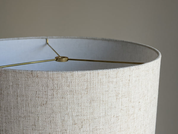 close up of top edge of drum lampshade in Calacatta Gold Flax fabric with brass hardware
