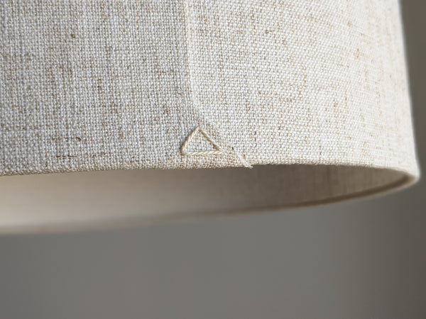 close up of back seam detail with cream colored triangle stitch detail