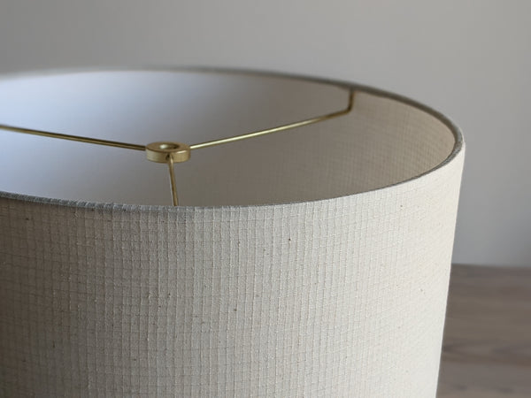 close up of cream colored Grid Ecru fabric on lamp shade with brass hardware