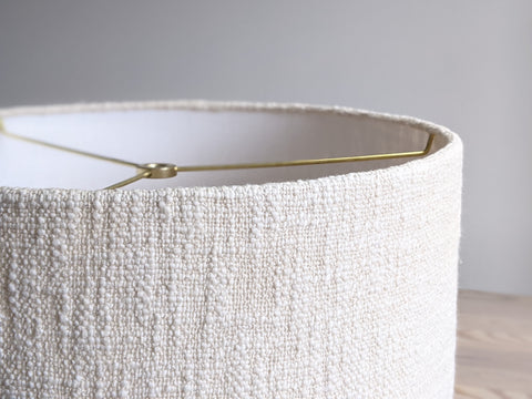 close up of edge details on a cream colored, handwoven fabric lamp shade 