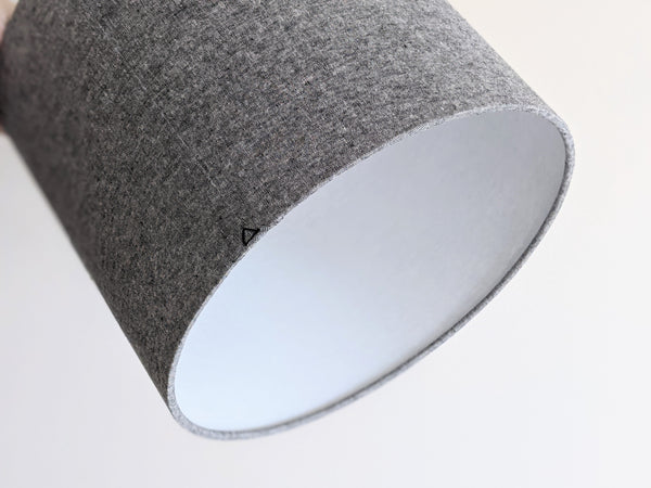 bottom edge of handmade lamp shade in black and white fabric shows the back seam with triangle stitch detail and the white interior lining of the shade