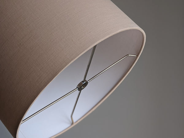 Close up of handmade lamp shade in blush linen with nickel hardware.