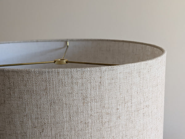 close up of top edge of drum lampshade in Calacatta Gold Flax fabric with brass hardware