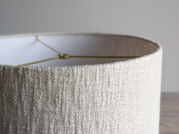 close up of edge details on a cream colored, handwoven fabric lamp shade